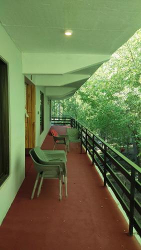 a balcony of a house with benches on it at Aangan Residences in Skardu