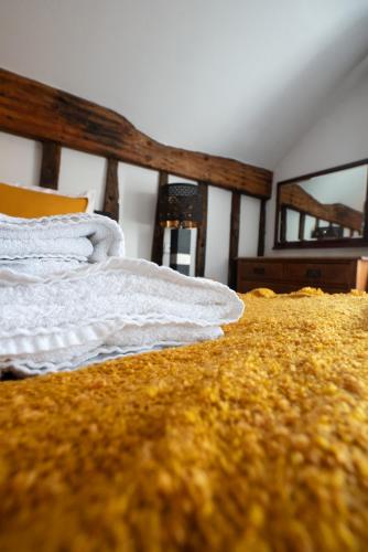 a bedroom with a bed with white sheets on it at Without A Paddle Hotel in Llangollen