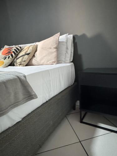 a bed with pillows on it in a room at BLUE DOOR BRASIL in Abraão