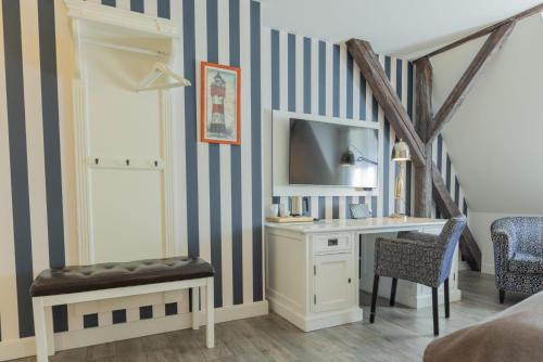 a room with a desk and a mirror at Best Western Plus Theodor Storm Hotel in Husum