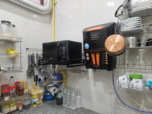 a kitchen with a microwave and a coffee maker on a wall at Ashirwaad 249 in Greater Noida