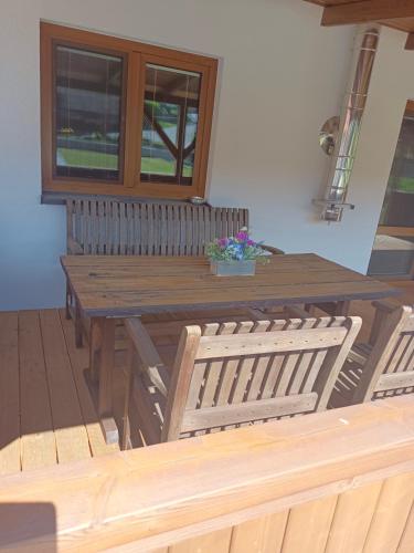 a wooden table and chairs in a room with a window at Odpočinek na vesničce in Mladá Vožice