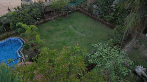 an aerial view of a garden with a swimming pool at SHELDON RESORT & SPA in Phalta