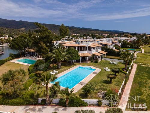 an aerial view of a resort with a swimming pool at Beachfront Villa Armonia in Porto Hydra by goutos properties in Ermioni