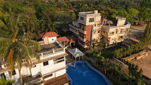 an aerial view of a large building with a swimming pool at SHELDON RESORT & SPA in Phalta