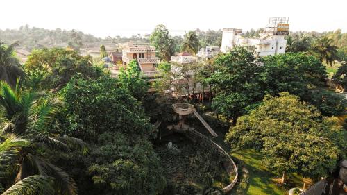 an amusement park with a roller coaster in the trees at SHELDON RESORT & SPA in Phalta