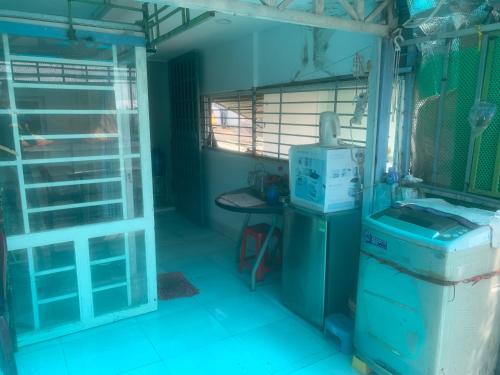 a kitchen with a refrigerator and a table in a room at Private Rooms-Low Price- Suburban of Saigon in Ho Chi Minh City