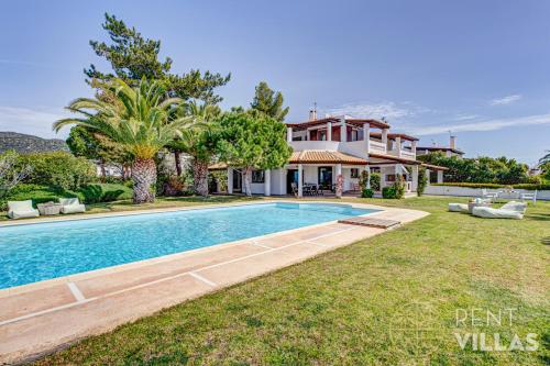 a villa with a swimming pool in front of a house at Beachfront Villa Armonia in Porto Hydra by goutos properties in Ermioni
