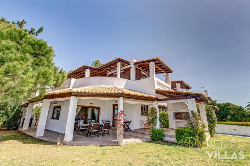 a villa with a view of a house at Beachfront Villa Armonia in Porto Hydra by goutos properties in Ermioni
