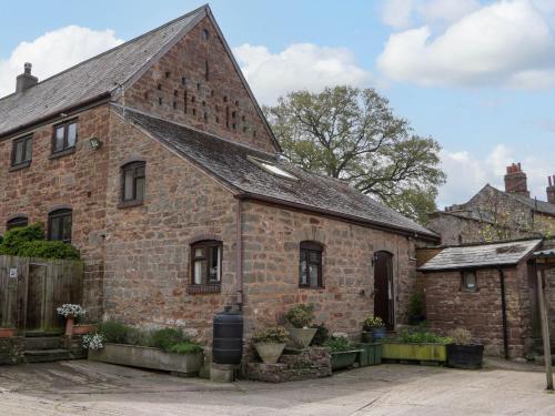 an old brick building with a triangular roof at The Cottage at Rocklands Farm in Ross on Wye