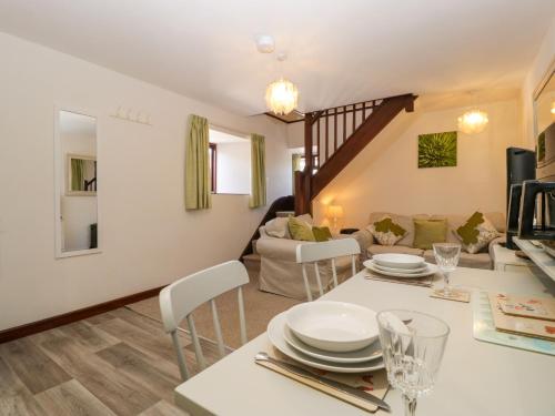 a kitchen and living room with a table and chairs at The Cottage at Rocklands Farm in Ross on Wye