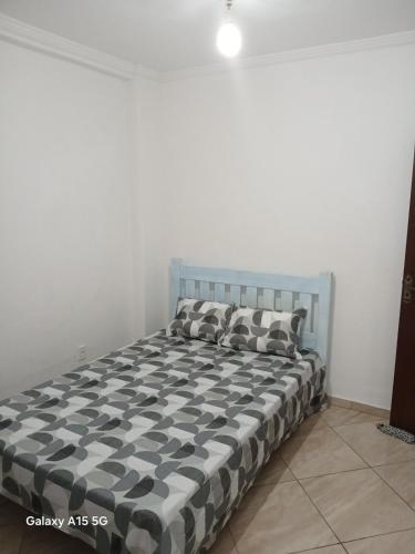 a bed with two pillows on it in a room at Condominium House in Iguaba in Iguaba Grande