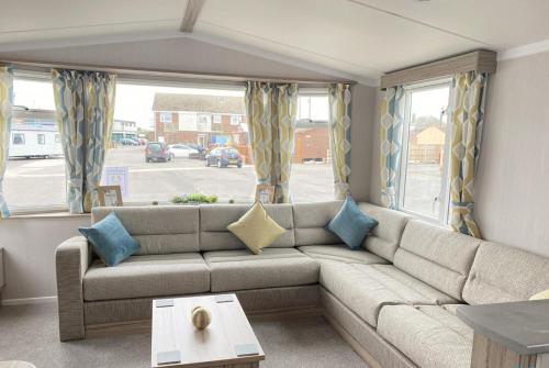 a living room with a couch and a window at 15 Willow Wynd Thurston Manor in Dunbar