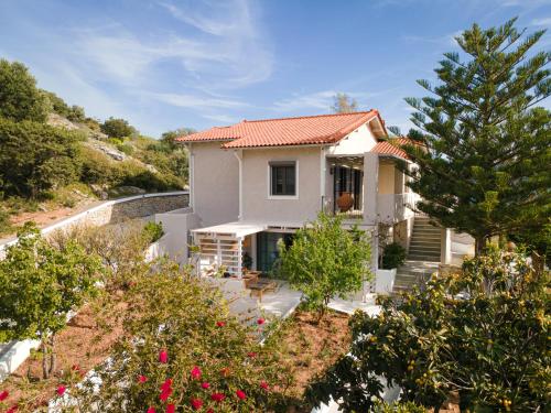 a white house with a red roof at Chariclea Villas Retreat in Samos