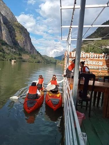 a group of people on a boat on a river at Cam u view Guest House in Nongkhiaw