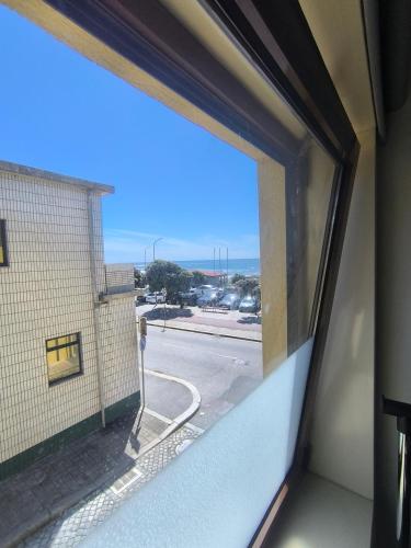 a window in a building with a view of a street at Casa Velha in Matosinhos