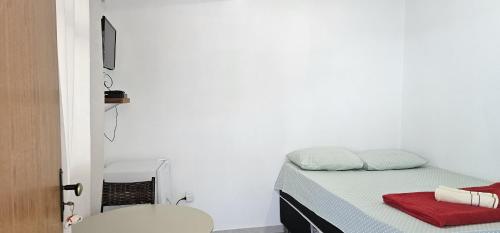 a small bedroom with a bed and a toilet at recanto Provetá 2 ILHA GRANDE in Praia de Provetá 