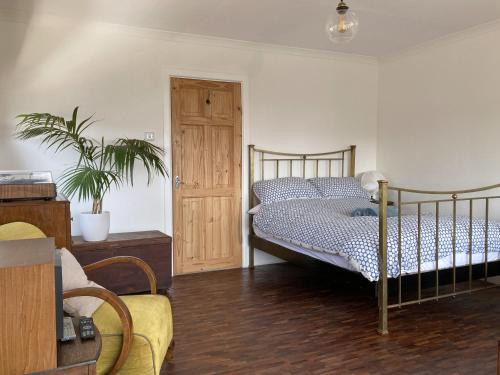 a bedroom with a bed and a potted plant at Paradise Heights in West Bay