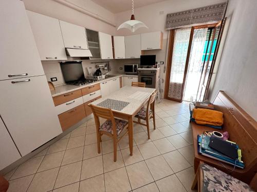 a kitchen with a table and chairs in a room at Leopardi 81 - 400 mt dall' AUTODROMO F1 in Imola