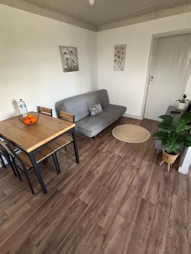 a living room with a couch and a table at Casa bela paisagem in Castro Daire