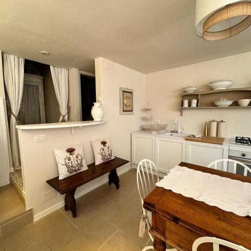 a kitchen with a table and a dining room at La Limonaia - Tremezzo by LoveComo in Tremezzo