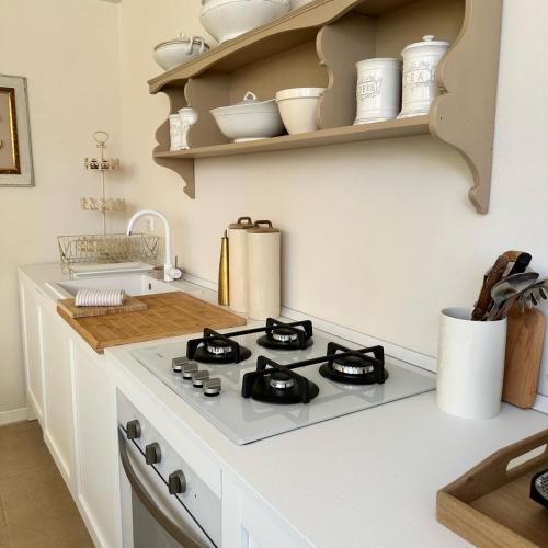 a kitchen with a stove top oven in a kitchen at La Limonaia - Tremezzo by LoveComo in Tremezzo
