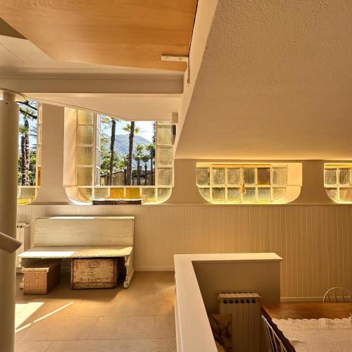 a room with two benches and two windows at La Limonaia - Tremezzo by LoveComo in Tremezzo