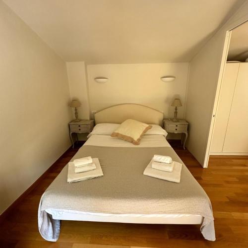 a bedroom with a bed with two towels on it at La Limonaia - Tremezzo by LoveComo in Tremezzo
