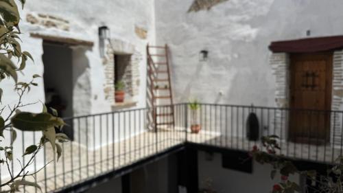 a balcony with a ladder on the side of a building at Apartamentos Jerez Siglo XIX in Jerez de la Frontera