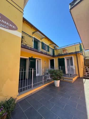 a yellow building with balconies and a patio at Affittacamere PZ in Vernazza