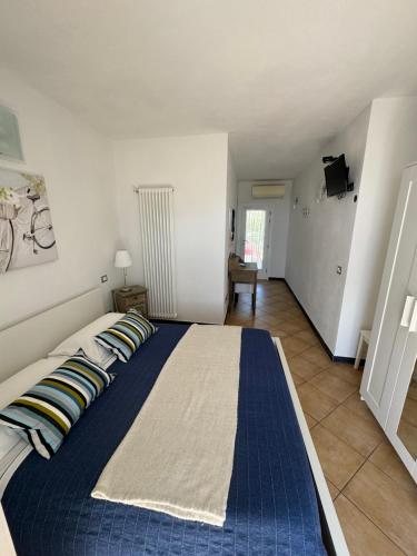 a bedroom with a blue bed with pillows on it at Affittacamere PZ in Vernazza