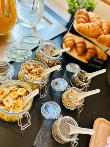a table topped with jars of food and pastries at Penzion Tenis HTK in Třebíč