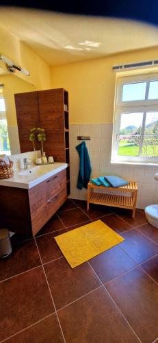 a bathroom with a tub and a sink and a window at Ferienhaus Rumpelt in Kurort Gohrisch