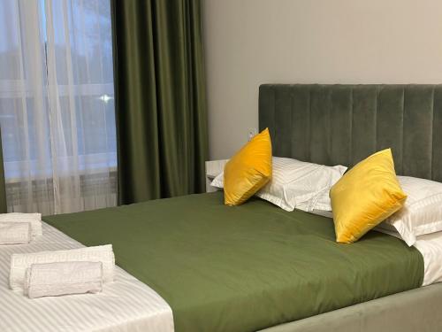 Ένα ή περισσότερα κρεβάτια σε δωμάτιο στο The Greens Apartment