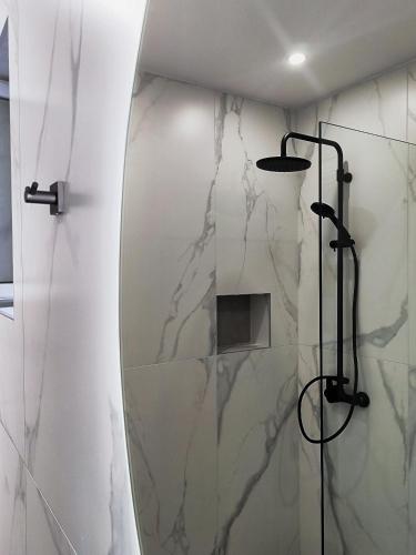 a bathroom with a mirror and a shower at Kyrva Bay Studios in Ierápetra