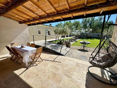 a patio with a table and chairs on a patio at Mas d'Andiol in Plan-dʼOrgon