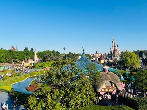 a group of people standing in front of a theme park at THE ENCHANTED HOUSE ( 15 min walk to Disney) in Serris