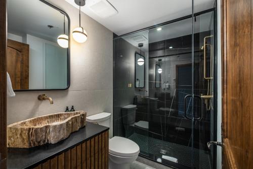 a bathroom with a sink and a shower at Bondurant Village Center Spectacular Condo in Mont-Tremblant