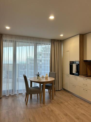 a kitchen and dining room with a table and chairs at Skyline studio 44 in Varna City