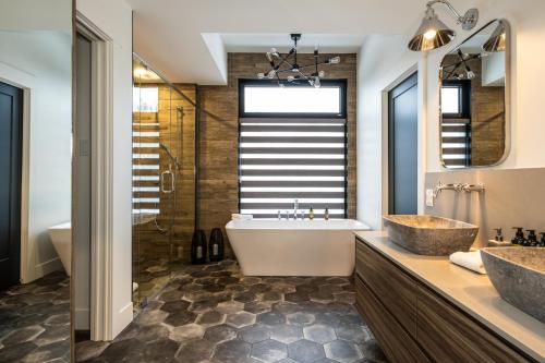 a bathroom with a tub and a sink at NEW! Chalet Forena 4 Bedrooms in La Conception