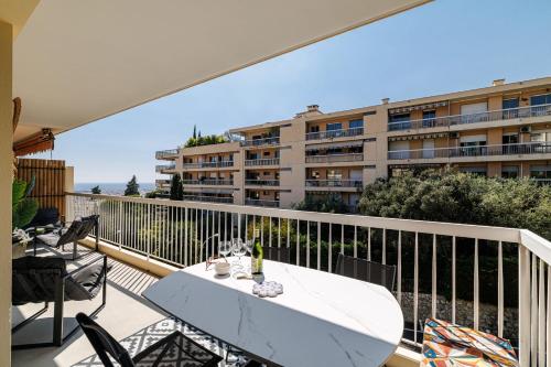 a balcony with a table with a surfboard on it at GAIRAUT - 5 rooms - Terrass in Nice
