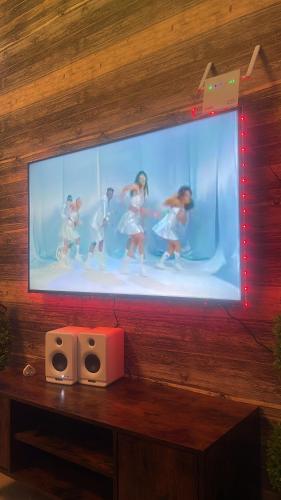 a television with a picture of people in a tub at Raheem luxury 3 bedroom in Jabang