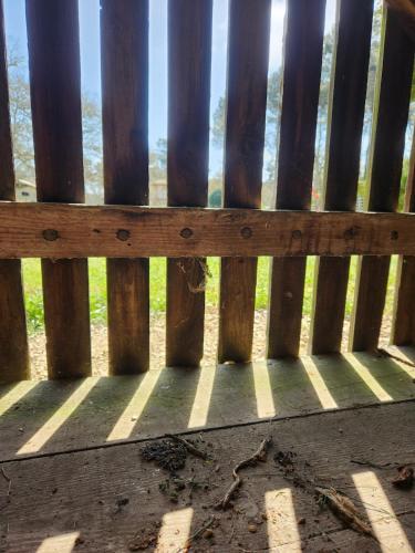 a wooden fence with a view of the ocean at Gîte sous les pins La grange à deux in Giscos