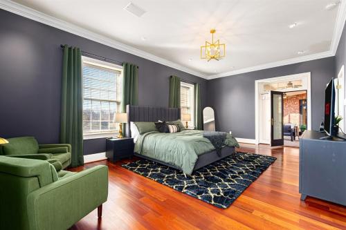 a bedroom with a bed and a couch and a television at Heated Pool, Hot Tub, Mini Golf, Theater-Sleeps 28 in Frankfort