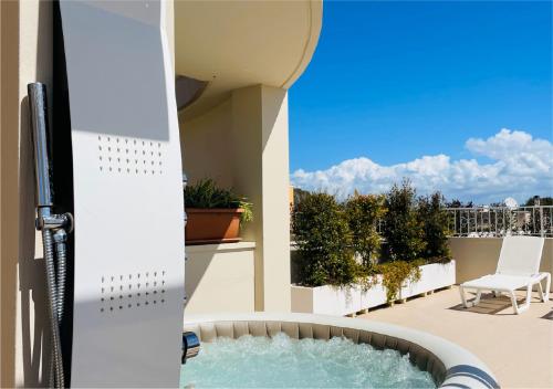 a view from the balcony of a house with a swimming pool at La Collina di Montegrappa - Suites with Heated Private Pool - Suites with Shared Pool in Tuglie