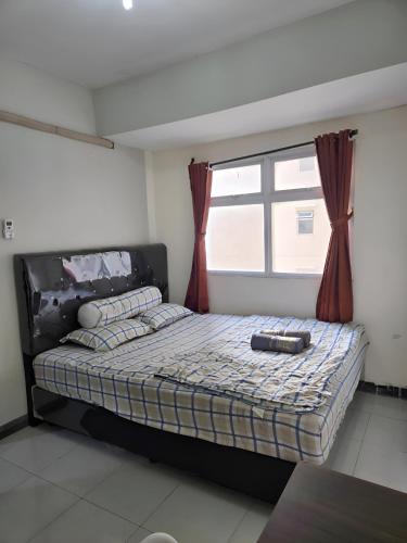 Postel nebo postele na pokoji v ubytování apartemen2BR cozy,cheapset pluit sea view