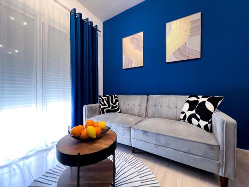 a living room with a couch and a bowl of fruit on a table at Roquetas Coastal Escape in Roquetas de Mar
