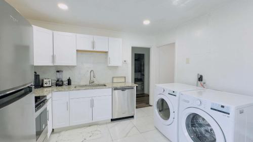 a white kitchen with a washing machine in it at Close to the beach #4 Cozy condo in Myrtle Beach