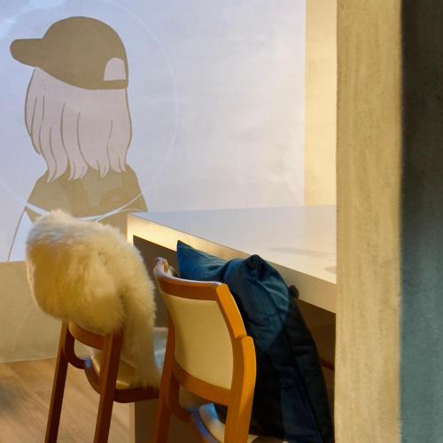 a table with two chairs and a backpack next to it at Shiki Villa Beppu in Beppu