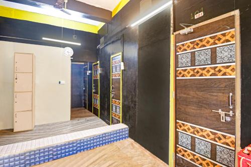 a room with a walk in shower and a door at Hotel O Mo Kudia in Brahmapur